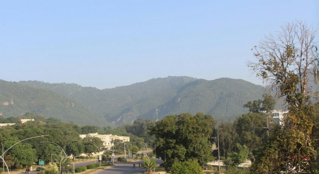 a view of a street with mountains in the background