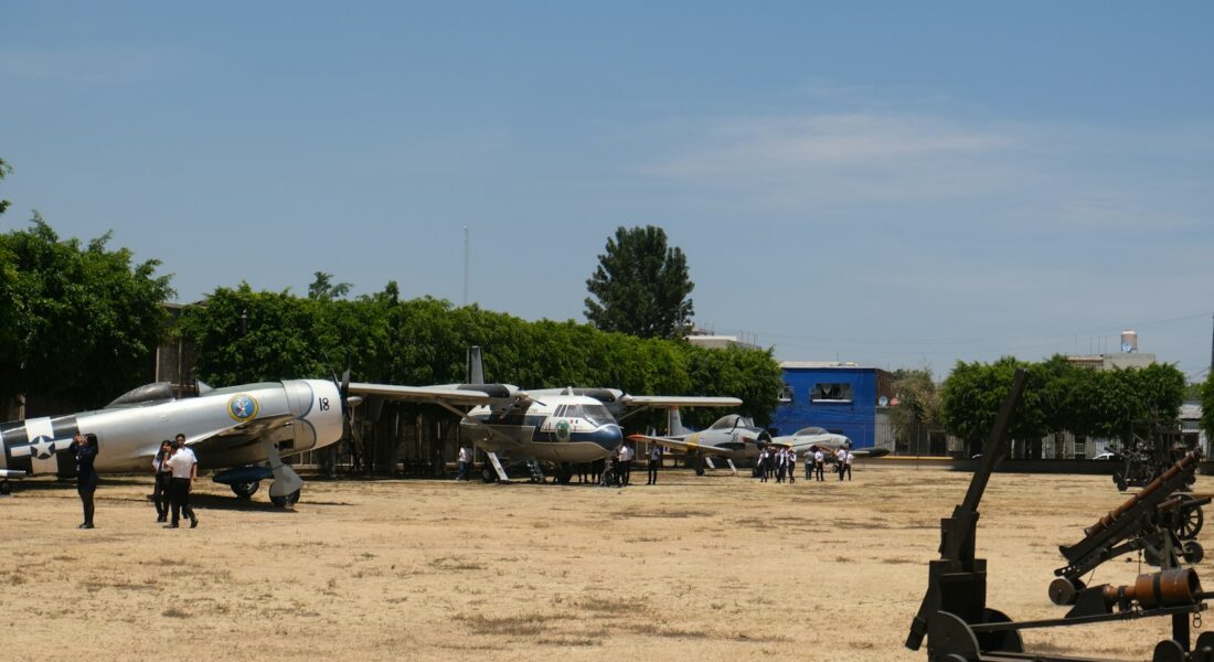 Airplanes displayed outdoors under a bright sky.